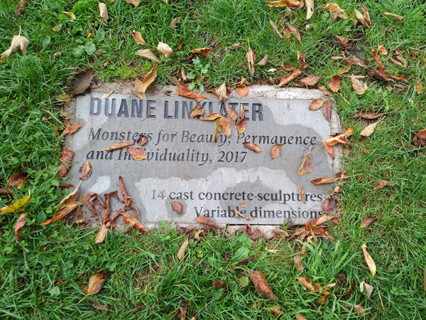 Nameplate in the grass for Duane Linklater's Monsters for Beauty, Permanence and Individuality installation