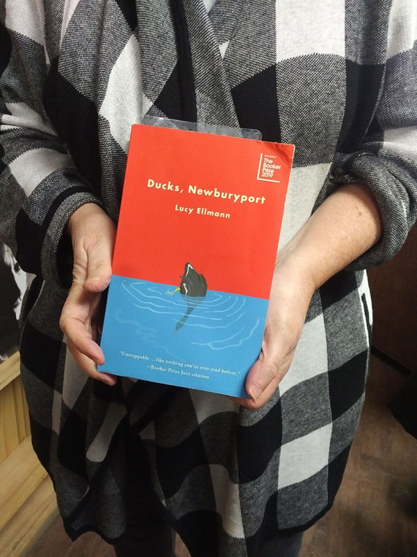 Silent book club member presents a book by Lucy Ellmann