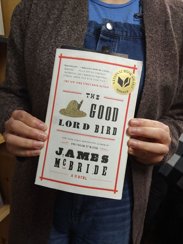 Silent book club member presents a book by James McBride