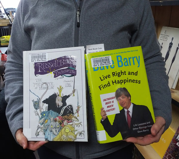 Silent book club member presents books by Russell Brand and Dave Barry