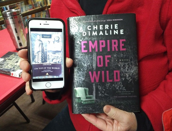 Silent book club member presents books by Barbara Foster and Cherie Dimaline