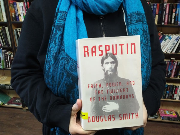 Silent book club participant holds the book Rasputin by Douglas Smith