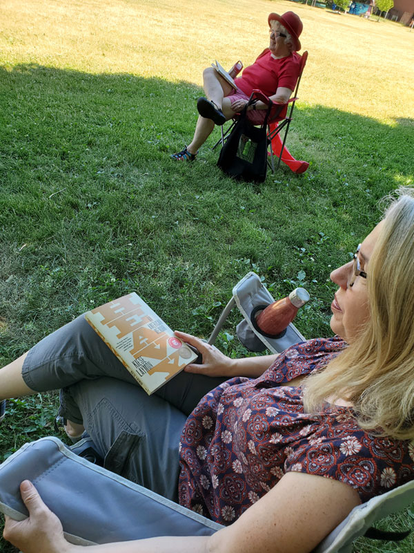 Silent book club member reading in the park