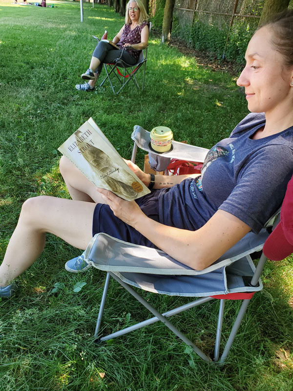 Silent book club member reading in the park