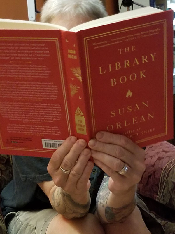 Silent book club member reads The Library Book by Susan Orlean