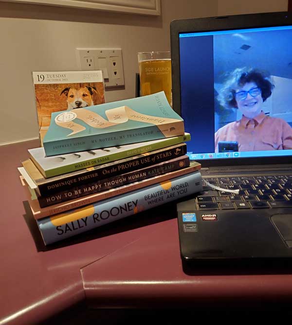Silent book club member Vicki, on screen, with her latest reading choices