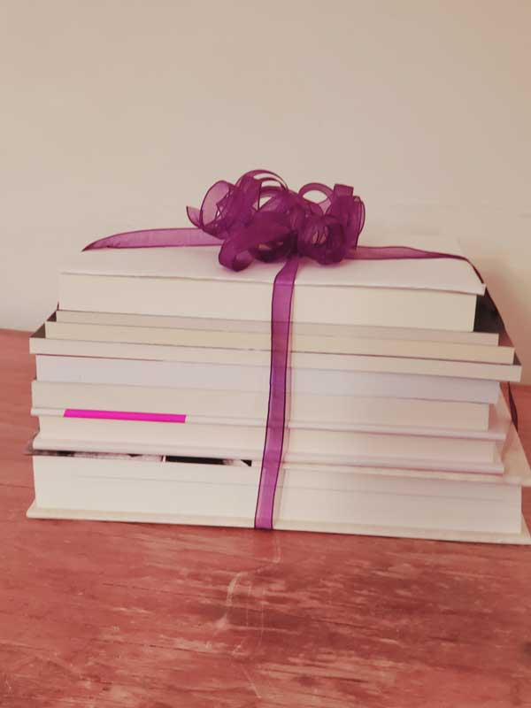 Stack of books with purple ribbon