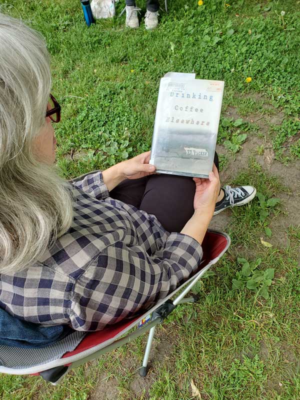 Catherine D in the park with a book