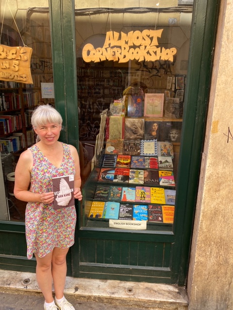 Silent book club member Catherine in front of the Almost Corner Bookshop in Rome
