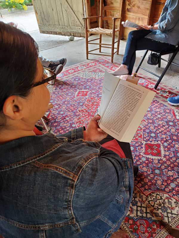 A silent book club member reads at The Great Escape garage.