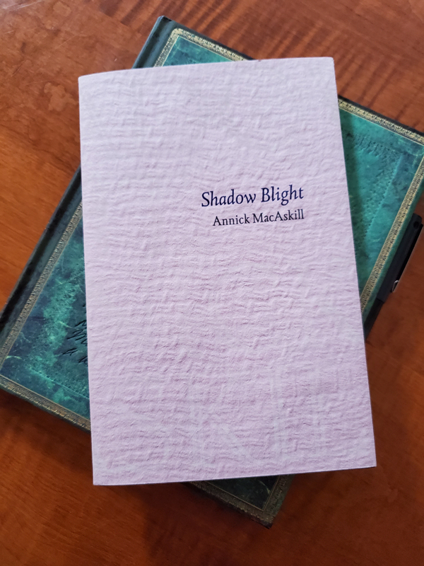 Poetry work Shadow Blight by Annick MacAskill with notebook with an ornate green cover