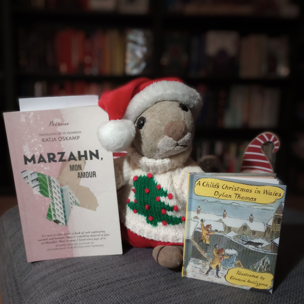 Squizzey the bookish squirrel has a Santa hat and a holiday jumper on, and he's showing off some of silent book club member Kath's recent reading, including A Child's Christmas in Wales by Dylan Thomas.
