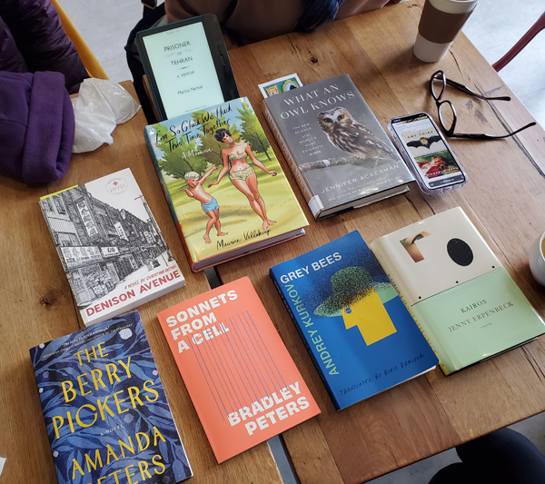 At East Toronto Coffee Co with books by by Daniel Innes & Christina Wong, Maurice Vellekoop, Jennifer Ackerman, Marina Nemat, Amanda Peters, Bradley Peters, Andrey Kurkov and Jenny Erpenbeck on the wooden table