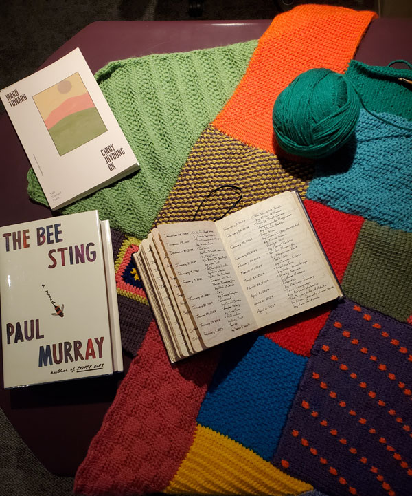 My treasured Book of Books (purple leather bound volume logging books read every year since 1983) sits on a colourful crocheted afghan work in progress. Two books with which I'm starting my 2025 reading sit with the Book of Books: The Bee Sting by Paul Murray and Ward Toward by Cindy Juyoung Ok. The Book of Books is open to the first two pages of reading that I logged 2024 - from January 2 to April 6, ranging from books by Lynn Tait to Elena Ferrante.