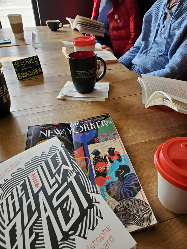 Readers around the table silently reading at East Toronto Coffee Co