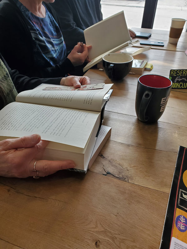 Readers around the table silently reading at East Toronto Coffee Co