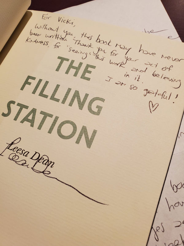 Close-up of the title page of the poetry collection The Filling Station by Leesa Dean, showing a personalized inscription