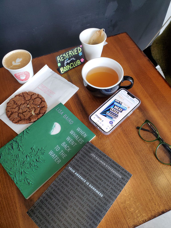 Books and hot beverages on the table at East Toronto Coffee Co, just before the start of the silent book club meeting