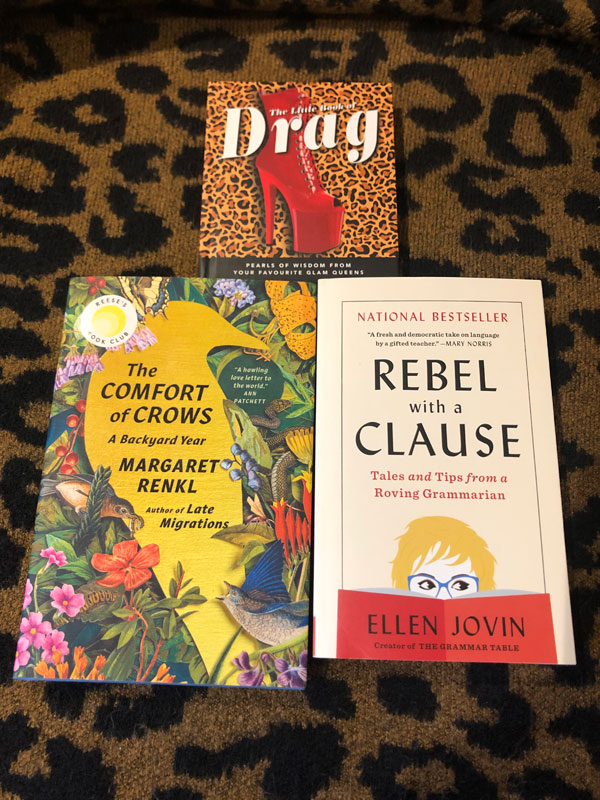 Silent book member Jen's books: The Little Book of Drag: Pearls of Wisdom from Your Favourite Glam Queens, The Comfort of Crows: A Backyard Year by Margaret Renkl and Rebel with a Clause: Tales and Tips from a Roving Grammarian by Ellen Jovin (Photo by Jennifer D. Foster)