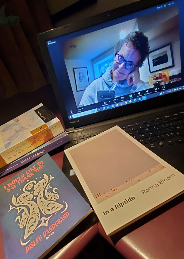 Silent book club member Vicki (that's me, with my signature messy hair and glasses), on screen getting ready for our zoom meeting, with books stacked next to my computer, including works by Marcel Proust, Ronna Bloom and Joseph Dandurand (Photo by Vicki Ziegler)