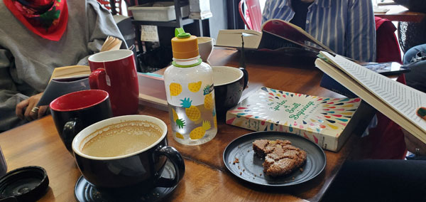 Readers reading at East Toronto Coffee Co, accompanied by coffee and pastries (Photo by Vicki Ziegler)