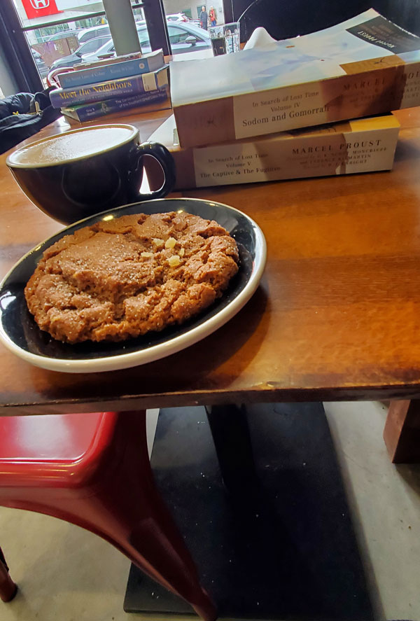 Group book pile at East Toronto Coffee Co, accompanied by coffee and pastries (Photo by Vicki Ziegler)