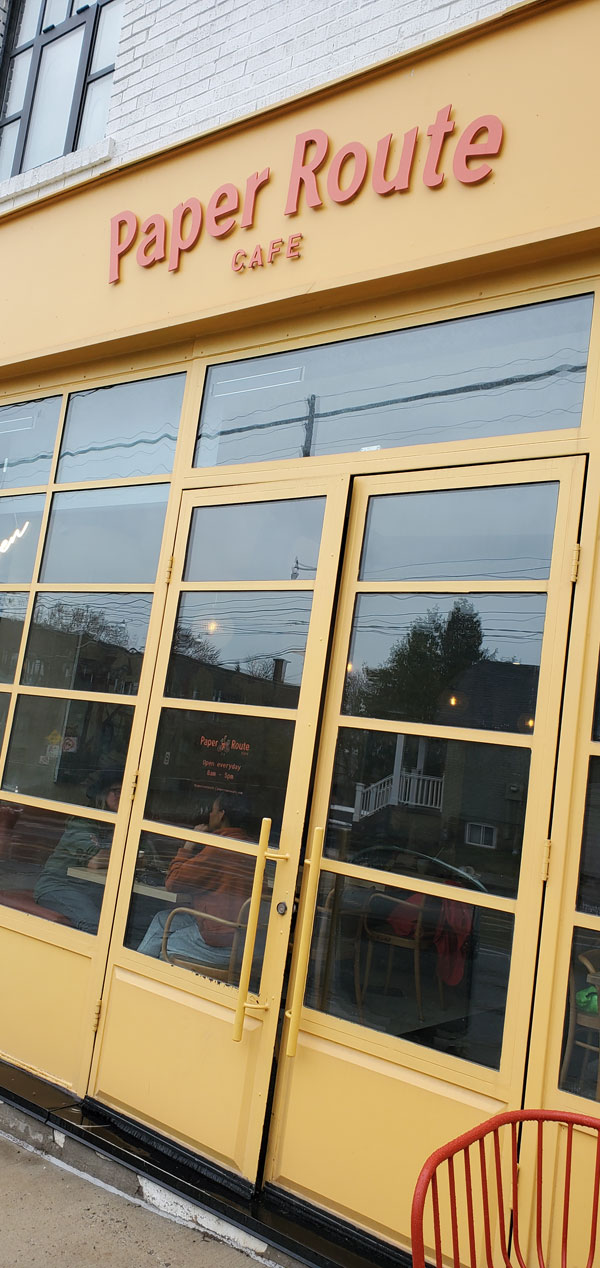 Bright yellow front door and windows of the Paper Route Cafe (Photo by Vicki Ziegler)
