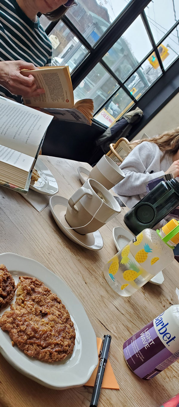 Readers reading at Paper Route Cafe, accompanied by refreshments (Photo by Vicki Ziegler)