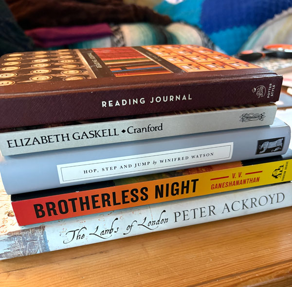 Silent book club member Sue's pile of recent reading, including The Lambs of London by Peter Ackroyd (Photo by Sue Reynolds)