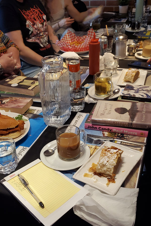 Readers reading at Budapest Restaurant, accompanied by refreshments (Photo by Vicki Ziegler)