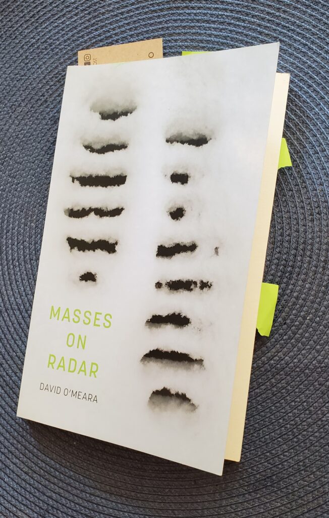 Poetry collection Masses on Radar by David O'Meara (Coach House Books) with green post-it notes jutting out of it
