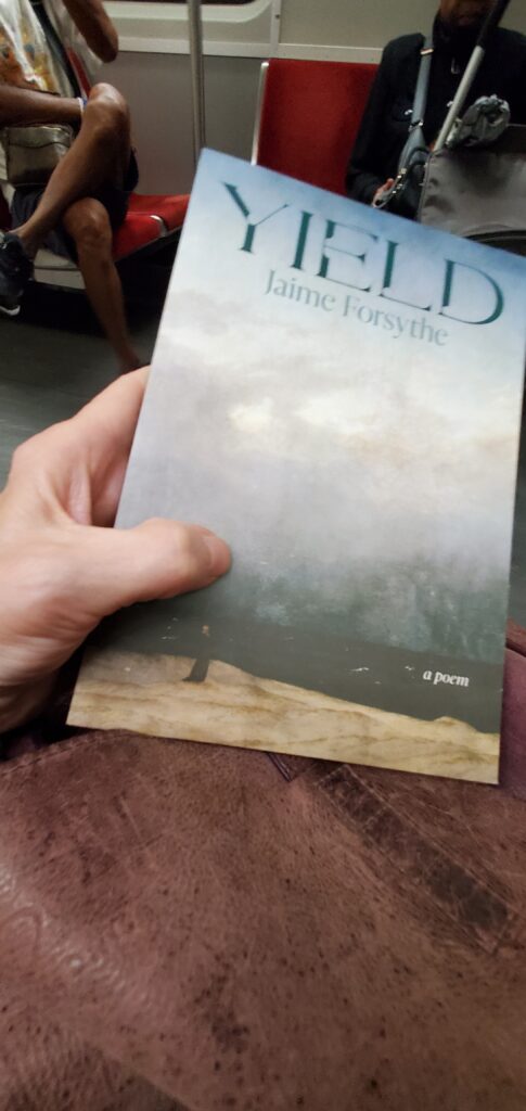 Poetry collection Yield by Jaime Forsythe (Wolsak & Wynn), resting on a purple leather purse as the reader shares the Toronto subway with fellow passengers